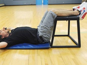 Personal trainer Kevin Murray demonstrates the relaxing 90/90 position that instantly relieves many aches and pains caused by bad posture and the downward pressure of gravity. (Postmedia News)