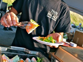 David Lee serves fresh vegetable spring rolls at the Fork and Cork Festival on Saturday, July 7, 2012. Thai Palace was one of the 18 local restaurants that were featured at the festival. (REBECCA WRIGHT/ The Windsor Star)