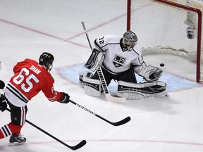 Chicago's Andrew Shaw, left, scores a goal in the first period of Game 2 of the Western Conference final past goaltender Jonathan Quick at United Center on June 2, 2013 in Chicago, Illinois.  (Photo by Jonathan Daniel/Getty Images)
