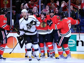 Chiacgo's Andrew Shaw, centre, celebrates his goal with teammates Viktor Stalberg, Michal Rozsival and Nick Leddy as Los Angeles' Trevor Lewis skates away during Game 2 of the Western Conference final at United Center on June 2, 2013 in Chicago, Illinois.  (Photo by Jamie Squire/Getty Images)