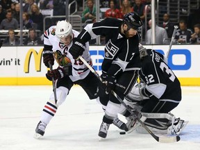 Chicago's Jonathan Toews and Rob Scuderi of the Los Angeles Kings look for the rebound during Game 4 of the Western Conference final at Staples Center on June 6, 2013 in Los Angeles. (Jeff Gross/Getty Images)