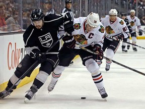 Los Angeles defenceman Drew Doughty, left, and Chicago's Jonathan Toews battle for the puck during Game 4 of the NHL Western Conference final in Los Angeles Thursday, June 6, 2013. (AP Photo/Reed Saxon)