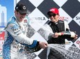 France's Simon Pagenaud, left, celebrates winning the IZOD IndyCar Series Chevrolet Indy Dual in Detroit at the Raceway at Belle Isle Park June 2, 2013 in Detroit. (Kevin C. Cox/Getty Images)