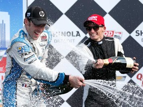 France's Simon Pagenaud, left, celebrates winning the IZOD IndyCar Series Chevrolet Indy Dual in Detroit at the Raceway at Belle Isle Park June 2, 2013 in Detroit. (Kevin C. Cox/Getty Images)