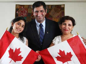 Daniel Arya, centre, with his wife, Nosrat Shahin, right, and his daughter, Ayrin Arya, 10, are pictured at their home, Friday, June 28, 2013.  The Arya family are Iranians who moved to Canada in 2007 and are currently waiting to become Canadian citizens.  (DAX MELMER/The Windsor Star)
