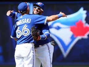 Toronto's Munenori Kawasaki, left, and Emilio Bonifacio celebrate a 13-5 win and a sweep against the Baltimore Orioles at the Rogers Centre June 23, 2013 in Toronto. (Abelimages/Getty Images)