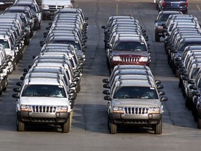 In this file photo taken Fed. 2, 2001, rows of 2001 Jeep Grand Cherokees are lined up outside the Jefferson North Assembly Plant in Detroit. The National Highway Traffic Safety Administration says on its website Thursday June 14, 2012 that it has added Jeep Liberty and Cherokee SUVs to the investigation. The probe now covers 5.1 million vehicles. The agency says 15 people have died in 26 Grand Cherokee fires. The investigation affects 1993 to 2004 Grand Cherokees. Also covered are 1993-2001 Cherokees and 2002-2007 Liberty's. (AP Photo/Carlos Osorio, File)