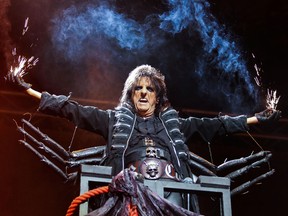 Alice Cooper holds sparklers during his set opening for Iron Maiden in Montreal, Wednesday July 11, 2012. (Postmedia News files)