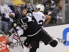Los Angeles centre Jarret Stoll, left, collides with Chicago defenseman Johnny Oduya during Game 3 of the Western Conference final Tuesday, June 4, 2013, in Los Angeles. (AP Photo/Jae C. Hong)