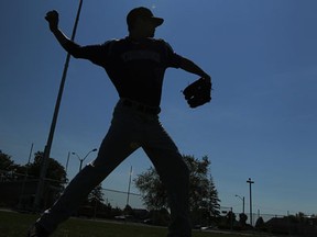 Tecumseh Thunder player Derrick Fortier warms up in the outfield in front of a new light pole during the unveiling of the $500,000 worth of renovations to the Lacasse Park baseball diamond in Tecumseh on Tuesday, June 5, 2013. The work will be concluded soon and features new lights, an outfield warning track and relocation of the outfield fences.             (TYLER BROWNBRIDGE/The Windsor Star)