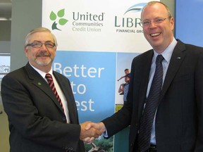 Jim Lynn, president and CEO of United Communities Credit Union, left, and Steve Bolton, president and CEO of Libro Financial Group, announced their intention to merge the co-operative financial institutions on June 5, 2013. (Photo courtesy of Libro Financial Group)