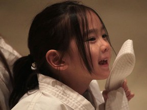 Bridget Leung, 5, proudly displays her new belt.    (DAN JANISSE/The Windsor Star)