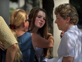 Members of the McLennan family console David's daughter Darla outside the courthouse after David's sentencing on June 27, 2013. (Nick Brancaccio / The Windsor Star)