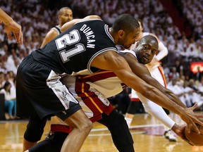 Miami's Dwyane Wade, right, looks to pass the ball against San Antonio's Tim Duncan during Game 7 of the NBA Finals June 20, 2013 in Miami. (Mike Ehrmann/Getty Images)