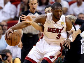 Miami's Dwyane Wade, left, drives against San Antonio's Danny Green during Game 2 of the  NBA Finals at AmericanAirlines Arena June 9, 2013 in Miami. The Heat beat the Spurs 103-84. (Christian Petersen/Getty Images)