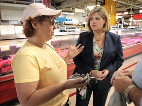 Andrea Horwath (R), leader of the provincial NDP  chats with Jocelyn Perrier, Tuesday, June 18, 2013, at the Market Square in Windsor, Ont. Horwath and a several other NDP MPPs toured the market and chatted with vendors and customers. (DAN JANISSE/The Windsor Star)