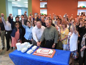 John Farrow, vice-chairman, and his brother Rick Farrow, CEO and chairman, are surrounded by Farrow employees as they cut a cake displaying the company's new logo and name during a gathering on June 10, 2013 in Windsor, Ontario. (JASON KRYK/The Windsor Star)