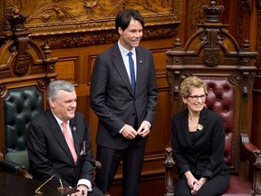 Ontario Lieut.-Gov. David Onley and Premier Kathleen Wynne pose with Eric Hoskins at a swearing-in ceremony at Queen's Park in Toronto on Feb. 11, 2013. (Canadian Press files)