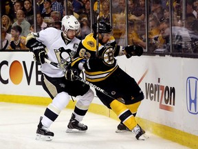 Boston's Brad Marchand, right, battles Pittsburgh's Sidney Crosby during Game 3 of the Eastern Conference final at the TD Garden on June 5, 2013 in Boston, Massachusetts.  (Photo by Bruce Bennett/Getty Images)