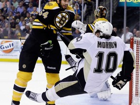 Boston's Adam McQuaid, left, checks Pittsburgh's Brenden Morrow in Game 3 of the Eastern Conference finals in Boston on Wednesday, June 5, 2013. (AP Photo/Elise Amendola)