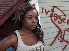 Downtown Windsor resident Alicia Culley, 24, shows some of the racist graffiti that she found at her place on Friday morning. Photographed June 14, 2013. (Nick Brancaccio / The Windsor Star)