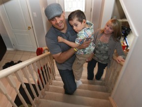 Jalil and Julie Khoury are shown with their son Alexander, 5, at their east Windsor home. They are planning on selling the house and building a home that provides accessible features for their special needs son. (DAN JANISSE / The Windsor Star)