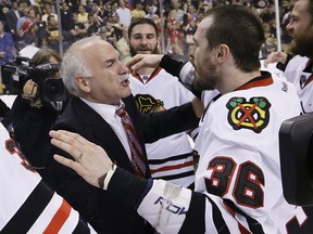 Chicago Blackhawks head coach Joel Quenneville and Chicago Blackhawks center Dave Bolland (36) celebrate the Stanley Cup championship after the Blackhawks beat the Boston Bruins 3-2in Game 6 of the NHL hockey Stanley Cup Finals Monday, June 24, 2013, in Boston. (AP Photo/Elise Amendola)
