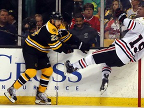 Boston's Chris Kelly, left, collides with Chicago's Jonathan Toews in Game 4 of the Stanley Cup final at TD Garden June 19, 2013 in Boston. (Elsa/Getty Images)