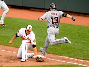 Detroit's  Alex Avila, left, hits into a double play as Batlimore's Chris Davis makes the catch in the seventh inning June 2, 2013 at Oriole Park at Camden Yards in Baltimore. The Orioles beat the Tigers 4-2. (Mitchell Layton/Getty Images)