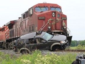 The remains of a  Ford Explorer driven by a single occupant sits on the Canadian Pacific rail tracks after a collision near Wallace Line in Lakeshore, Ontario on June 6, 2013. Ontario Provincial Police are investigating the accident the occupant to hospital with life-threatening injuries. (JASON KRYK/The Windsor Star)