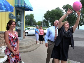 Ontario NDP Leader Andrea Horwath, right, sets the volleyball during a visit with Windsor Tecumseh candidate Percy Hatfield, behind, at Stop 26 Ice Cream Monday July 8, 2013.  Area resident Michele Carignan, left, watches as Horwath volleys with her daughter Marilou (not shown) at Stop 26 Ice Cream. (NICK BRANCACCIO/The Windsor Star)