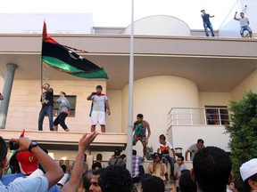 Libyan protesters attack the offices of Muslim Brotherhood-backed Party of Justice and Construction, in the Libyan capital Tripoli on July 27, 2013.  Protesters attacked offices of Libya's Muslim Brotherhood as demonstrations sparked by a wave of assassinations in the eastern city of Benghazi turned violent, an AFP correspondent said.   AFP PHOTO/MAHMUD TURKIAMAHMUD TURKIA/AFP/Getty Images