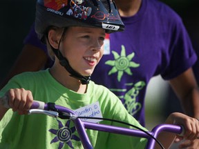 Camden Candless, 9, learns how to ride a two-wheel bike South Windsor Arena, Friday, July 12, 2013.  I Can Bike is a week-long camp that teaches kids with special needs how to ride a bike.  (DAX MELMER/The Windsor Star)