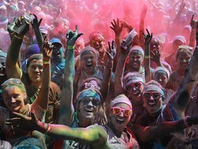 Runners covered in coloured powder celebrate at The Color Run's Finish Line Festival at the Riverfront Festival Plaza, Saturday, July 20, 2013.  (DAX MELMER/The Windsor Star)
