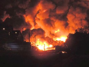 Flames shot several metres into the air after a train carrying crude oil derailed in the Quebec town of Lac-Megantic early Saturday, July 6, 2013.
(Anne-Julie Hallée , YouTube)