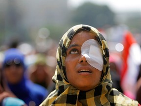 Zinab al-Saghier, an an opponent of Egypt's ousted president Mohammed Morsi, who said she lost her eye during recent clashes with Morsi supporters, shouts anti-Muslim Brotherhood slogans during a protest in Tahrir Square, in Cairo, Egypt, Friday, July 5, 2013. Egypt's interim president held talks Saturday with the army chief and interior minister following an outburst of violence between supporters and opponents of ousted leader Mohammed Morsi that killed at least 30 people across the country and deepened the battle lines in the divided nation. (AP Photo/Amr Nabil)