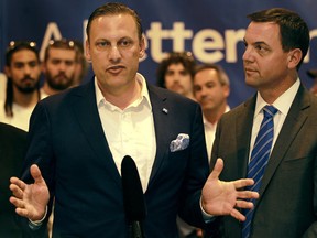 Windsor-Tecumseh Progressive Conservative candidate, Robert de Verteuil, left, is joined by Ontario Progressive Conservative leader, Tim Hudak, as he speaks at Valiant Training and Development Centre, Thursday, July 11, 2013.  (DAX MELMER/The Windsor Star)