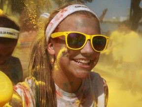 A young girl is sprayed with coloured powder as she participates in The Colour Run along Windsor's riverfront, Saturday, July 20, 2013.  (DAX MELMER/The Windsor Star)