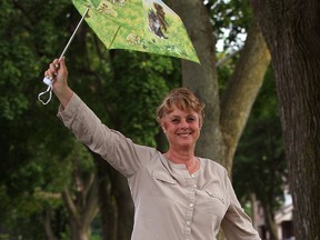 Marilyn Clancey is back in Windsor after moving away 40 years ago.  Clancey was taking a walk and had her unbrella ready in East Windsor Wednesday July 10, 2013. (NICK BRANCACCIO/The Windsor Star)