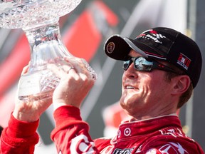 New Zealand's Scott Dixon lifts the trophy after winning the Honda Toronto Indy in Toronto Saturday. (THE CANADIAN PRESS/Chris Young)