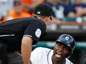 Detroit's Torii Hunter, right, looks to home plate umpire Quinn Wolcott for the call after scoring against the Texas Rangers from first base on a double by Victor Martinez in the second inning at Comerica Park Saturday. (Photo by Duane Burleson/Getty Images)