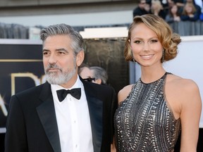 Actor George Clooney (L) and actress Stacy Keibler arrives at the Oscars at Hollywood & Highland Center in this February 24, 2013 file photo in Hollywood, California.  (Photo by Jason Merritt/Getty Images)