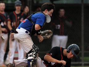 Team Alberta's Tyler Peacock, right, slides safely into home under the tag of Team Ontario's Josh Campbell at Mic Mac Park at the Canadian Little League Series. (TYLER BROWNBRIDGE/The Windsor Star)