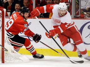 Detroit Red Wings defenceman Brendan Smith, right, tries to keep the puck from ex-Spit Bryan Bickell of the Blackhawks. (AP Photo/Nam Y. Huh)