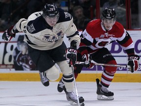 Windsor's Ty Bilcke, left, races for the puck against Ottawa's Matthieu Desautels at the WFCU Centre, (DAX MELMER/The Windsor Star)