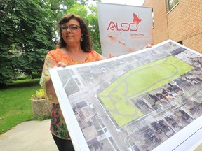 Lynn Calder, executive director for Assisted Living Southwestern Ontario,  displays on Friday, July 5, 2013, a map of Patterson Park in West Windsor that will have modifications made to make the park accessible. (JASON KRYK/The Windsor Star)
