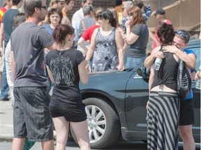 A tearful reunion takes place in front of Polyvalente Montignac in Lac Megantic , the school is housing 160 displaced members of the community and has become a gathering site for those looking for lost friends and family Sunday, July 7, 2013. (Peter McCabe , The Gazette)
