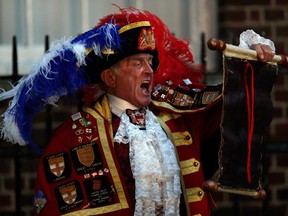 Tony Appleton, a town crier, announces the birth of the royal baby, outside St. Mary's Hospital exclusive Lindo Wing in London, Monday, July 22, 2013. Palace officials say Prince William's wife Kate has given birth to a baby boy. The baby was born at 4:24 p.m. and weighs 8 pounds 6 ounces. The infant will become third in line for the British throne after Prince Charles and William. (AP Photo/Lefteris Pitarakis)