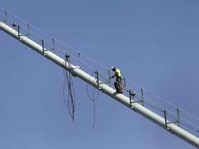 A technician works on a section of the Ambassador Bridge, Monday, July 15, 2013 in Windsor, Ont. (DAN JANISSE/The Windsor Star)