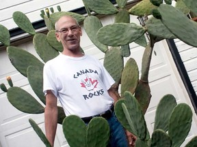 Windsor native Glen Boismier stands by his Arizona prickly pear cacti that stand in his yard on Clemenceau Boulevard on Saturday, July 27, 2013. (JOEL BOYCE / The Windsor Star)